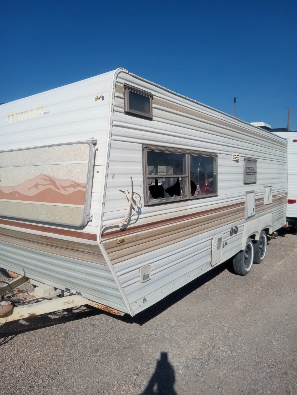 The actual vintage Skyline Nomad trailer in a storage yard before guest setup